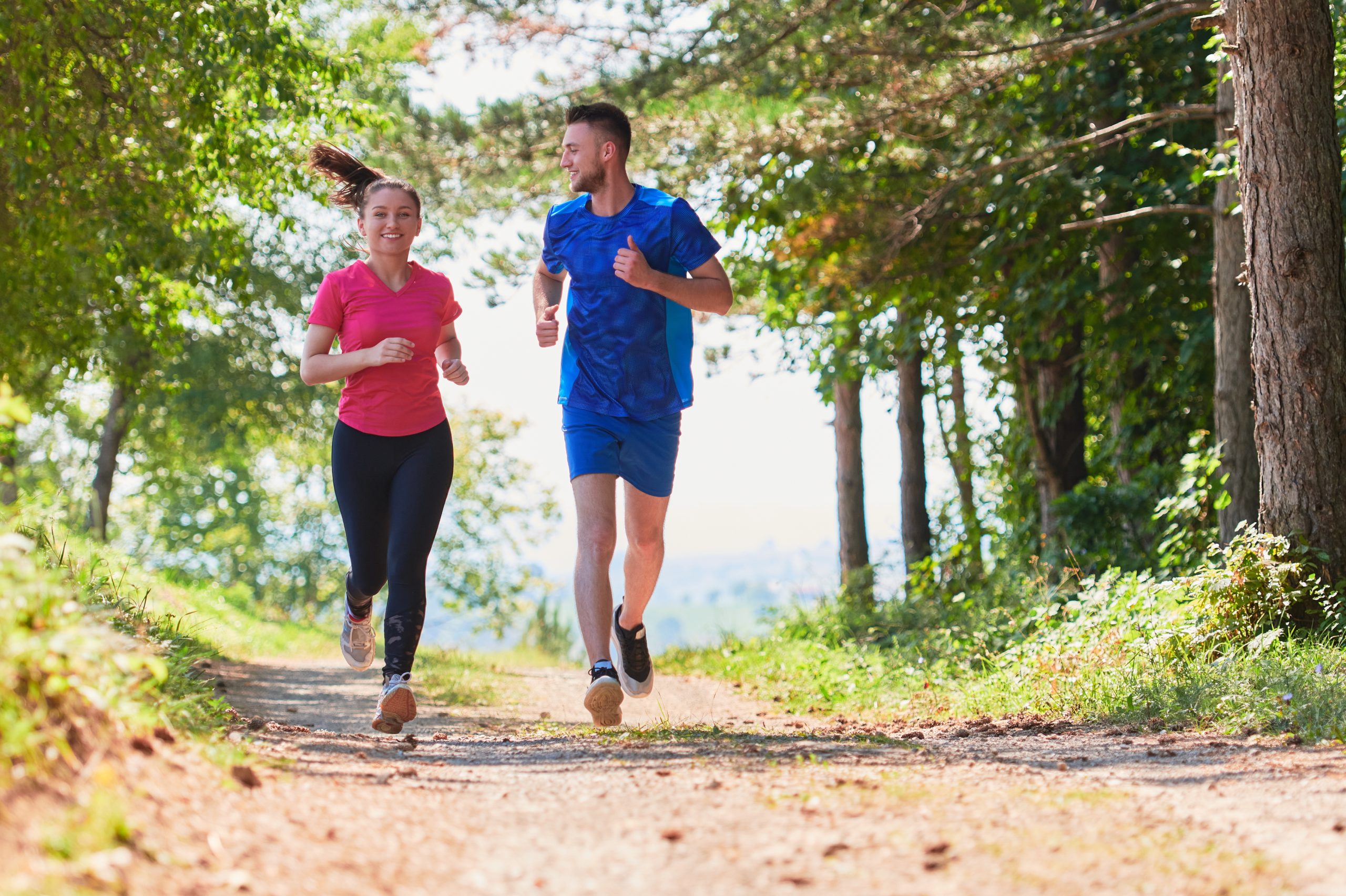 Happy couple running in the woods