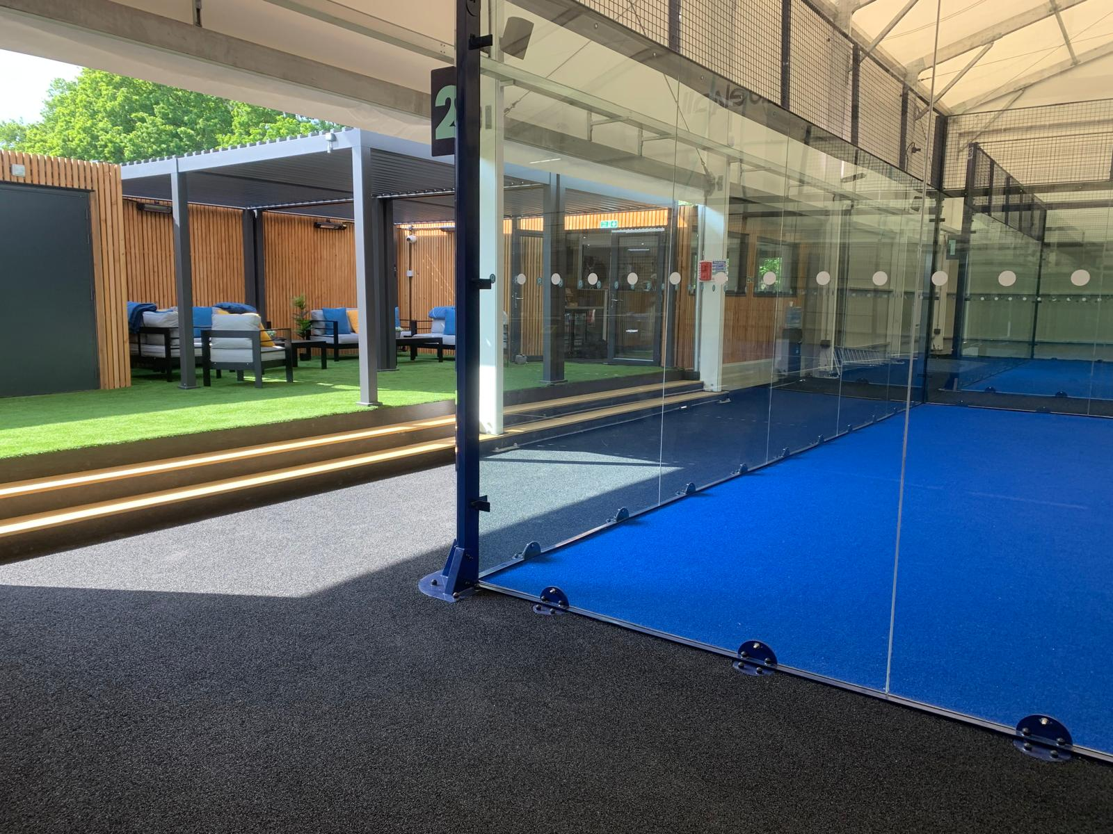 Court and seating area Side of the padel court with seating area