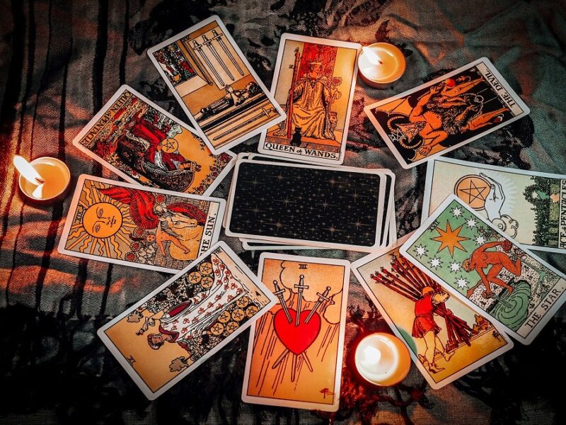 Tarot reading with tarot card background and candlelight on the